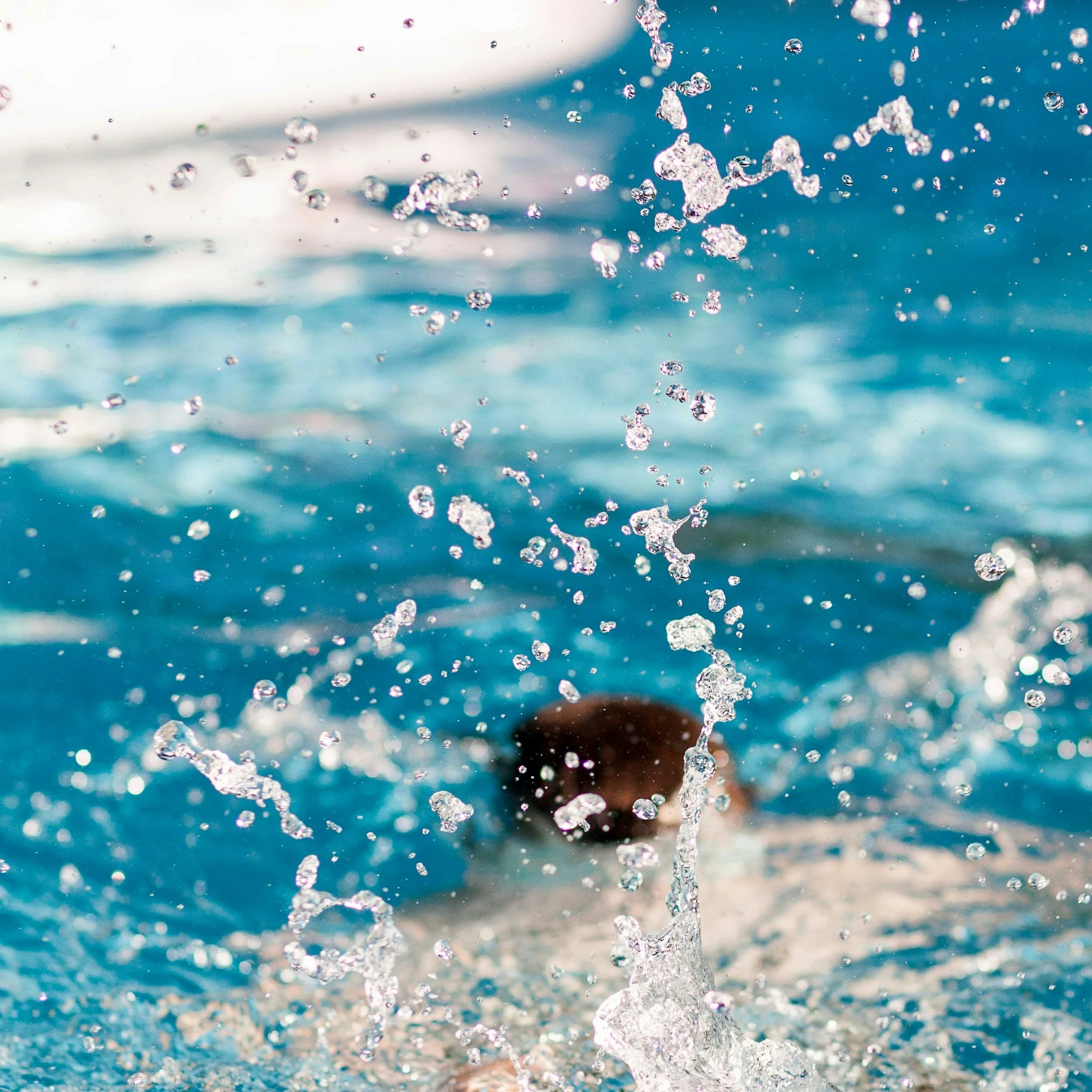 Crystal clear swimming pool water in an Arkansas backyard