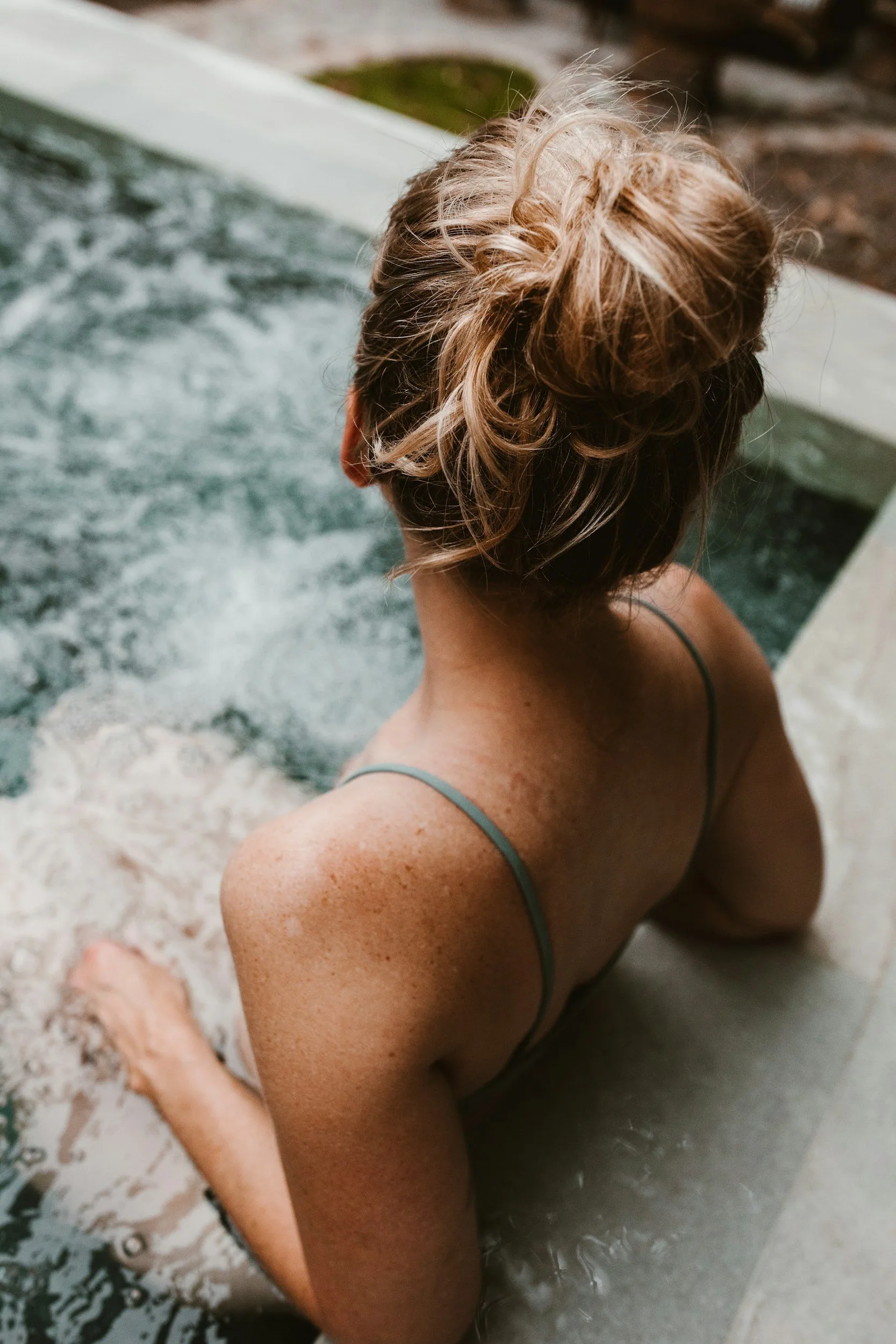 Homeowner relaxing by a well-maintained backyard pool in  Central Arkansas