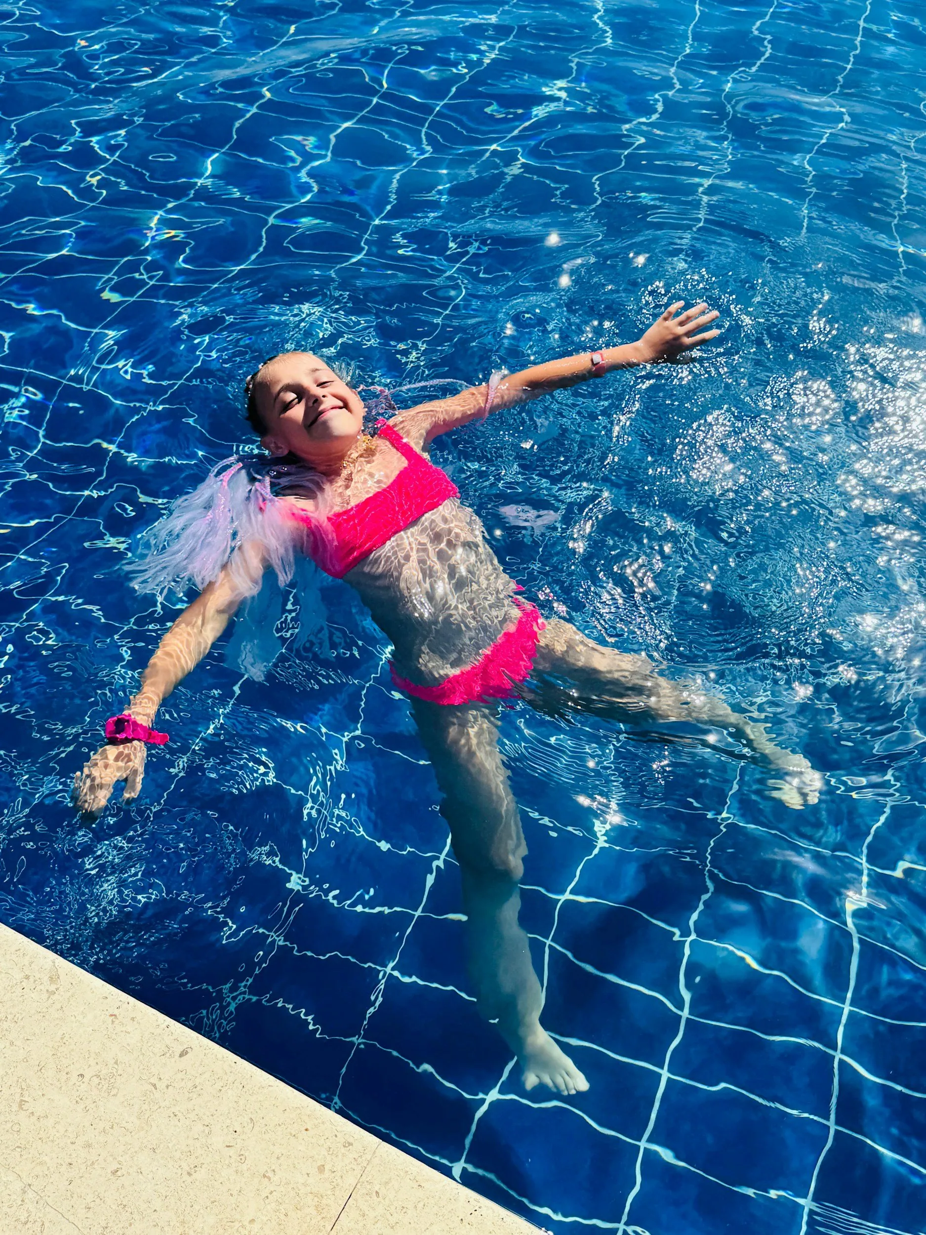 Homeowner relaxing by a well-maintained backyard pool in  Central Arkansas