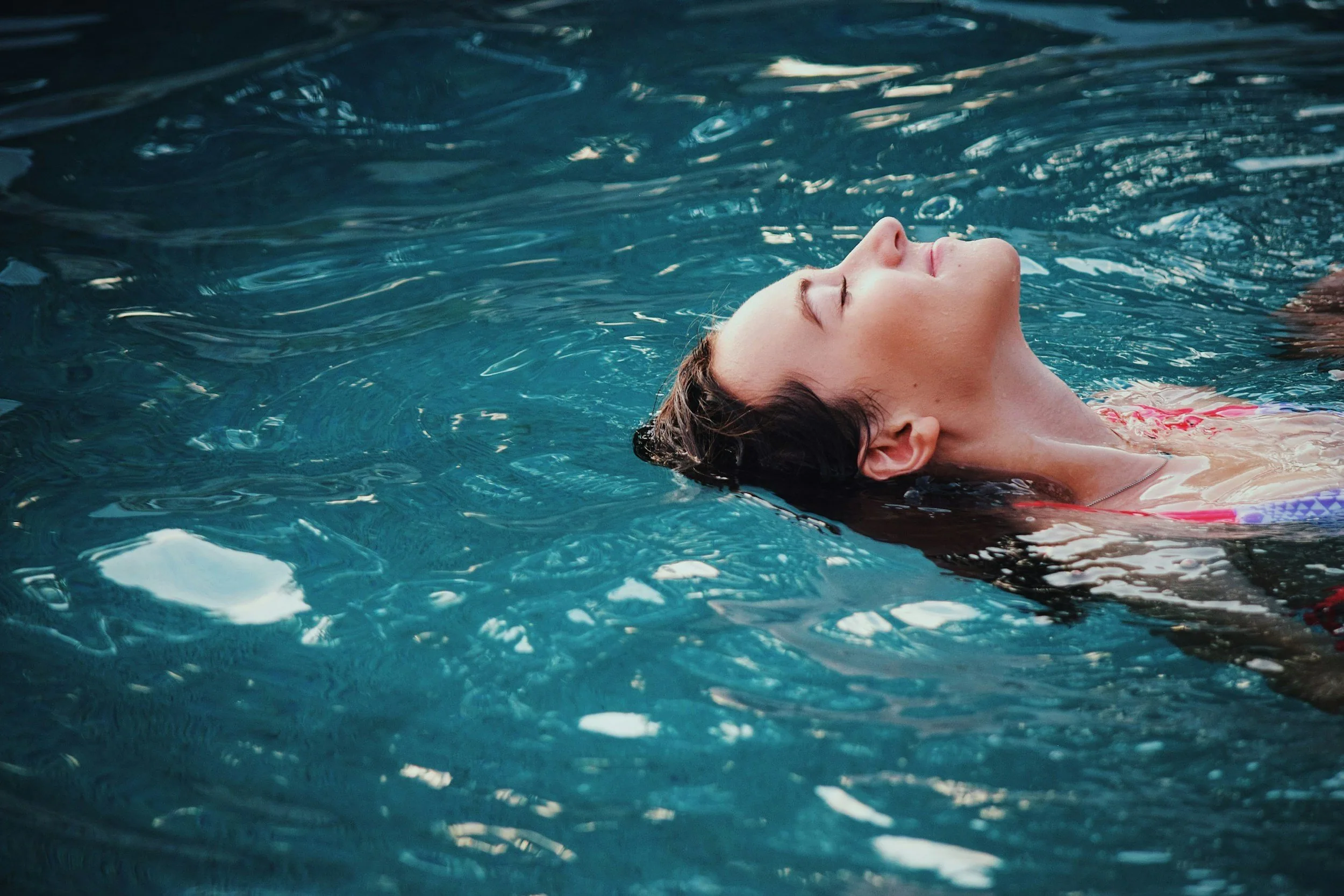 Homeowner relaxing by a well-maintained backyard pool in  Central Arkansas