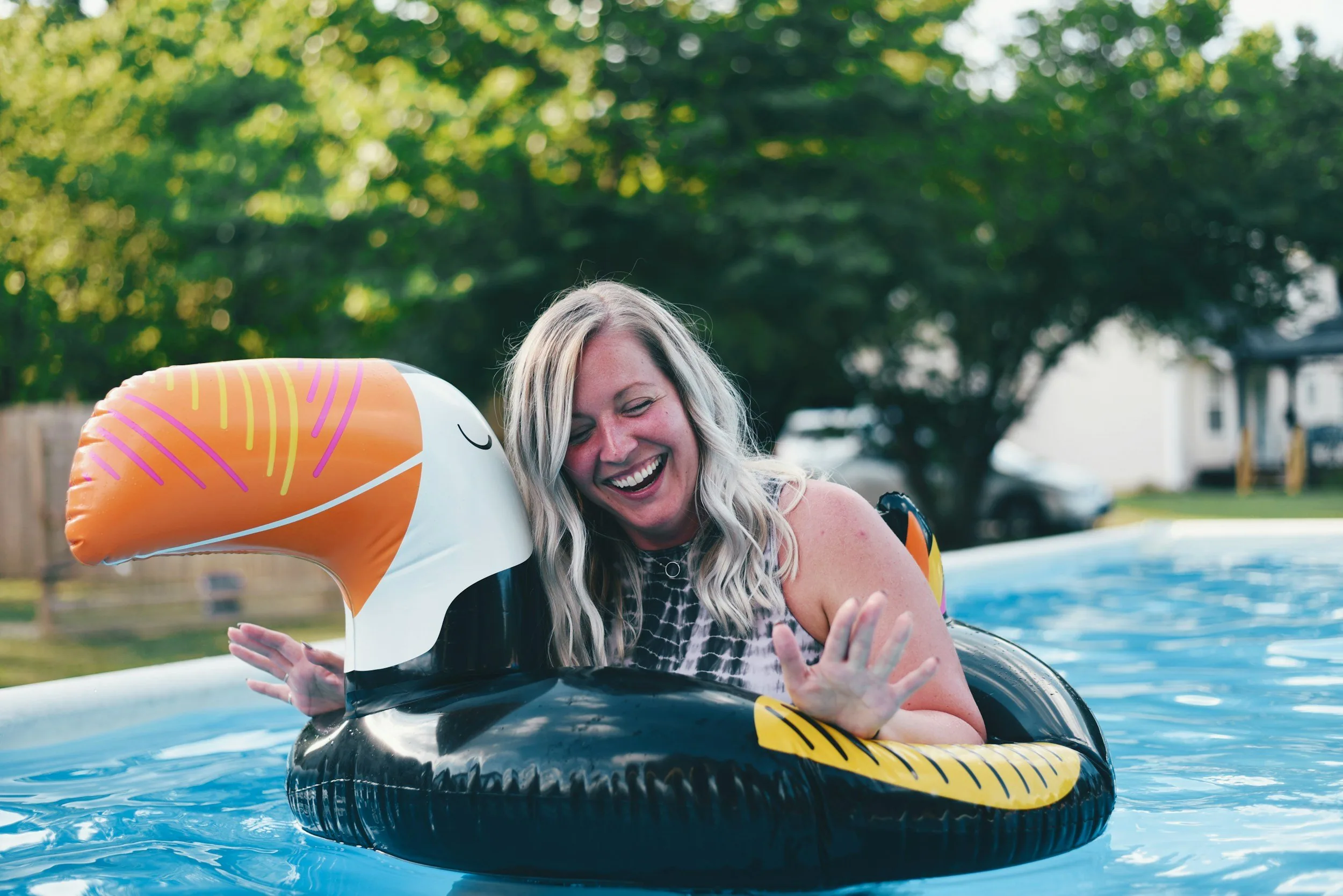 Homeowner relaxing by a well-maintained backyard pool in Chenal neighborhood of Little Rock, AR.